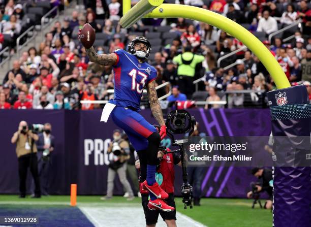 Mike Evans of the Tampa Bay Buccaneers and NFC celebrates after scoring a 19-yard touchdown against the AFC with a between-the-legs dunk through the...