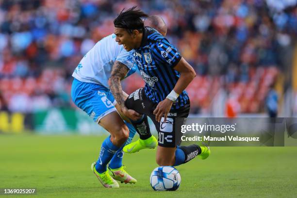 Gustavo Ferrareis of Puebla struggles for the ball against Jefferson Montero of Querétaro during the 4th round match between Queretaro and Puebla as...