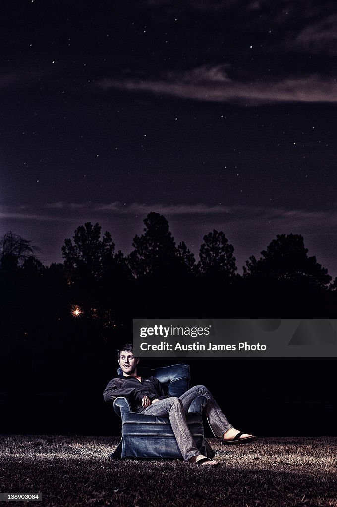 Young man sitting on chair