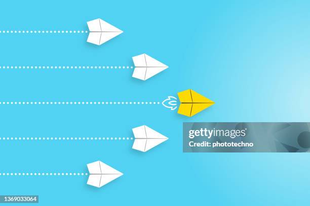 leadership concepts with yellow paper airplane leading among white - graphite stock illustrations