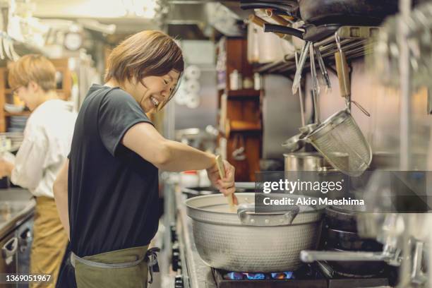 chefs preparing food in a japanese izakaya restaurant - stew pot stock pictures, royalty-free photos & images