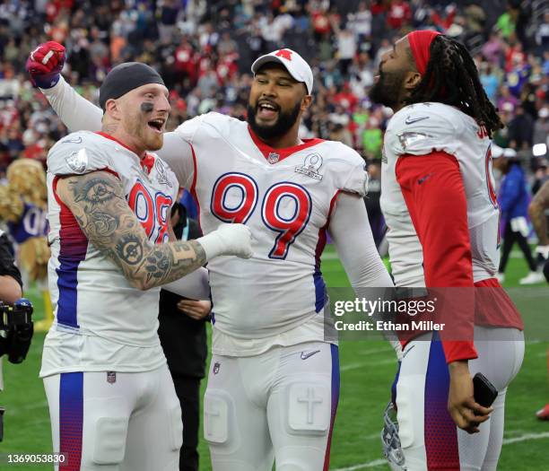 Maxx Crosby of the Las Vegas Raiders is congratulated by AFC teammates DeForest Buckner of the Indianapolis Colts and Matthew Judon of the New...