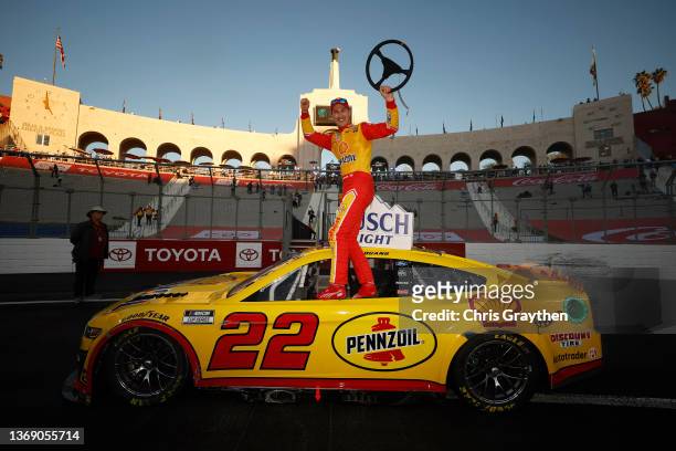 Joey Logano, driver of the Shell Pennzoil Ford, celebrates in victory lane after winning the NASCAR Cup Series Busch Light Clash at the Los Angeles...