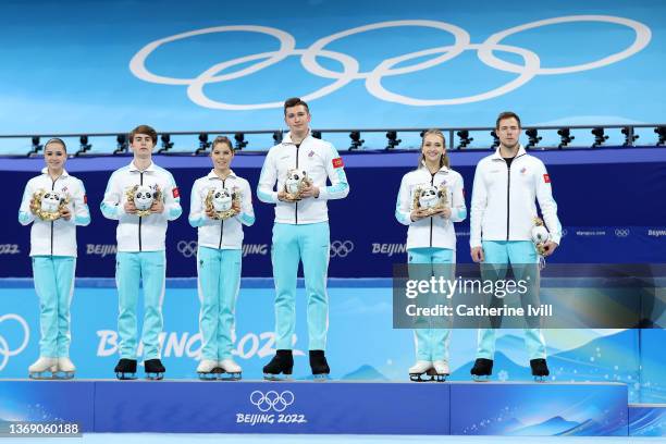 Gold medalists Team ROC pose during the Team Event flower ceremony on day three of the Beijing 2022 Winter Olympic Games at Capital Indoor Stadium on...