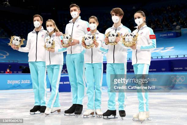 Gold medalists Team ROC pose during the Team Event flower ceremony on day three of the Beijing 2022 Winter Olympic Games at Capital Indoor Stadium on...