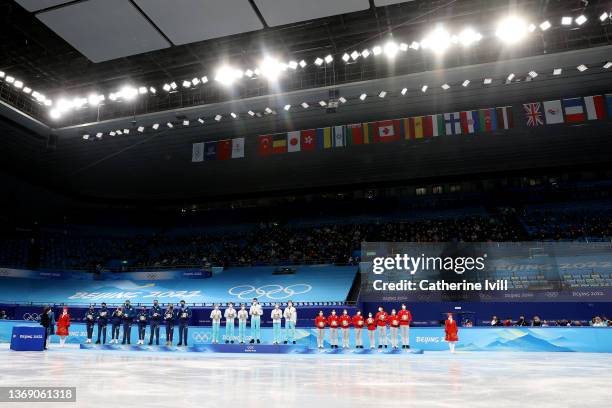 Gold medalist Team ROC , Silver medalist Team United States , and Bronze Medalist Team Japan pose during the Team Event flower ceremony on day three...