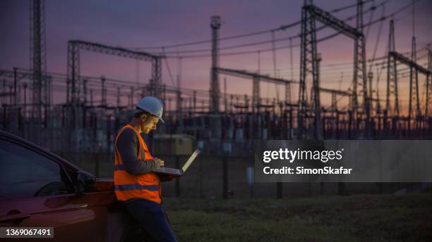 quality control on power station at dusk - electricity stockfoto's en -beelden