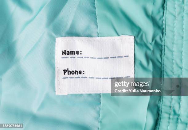 name and phone tag on clothes address for children and the elderly on a jacket. - branding identity stock pictures, royalty-free photos & images