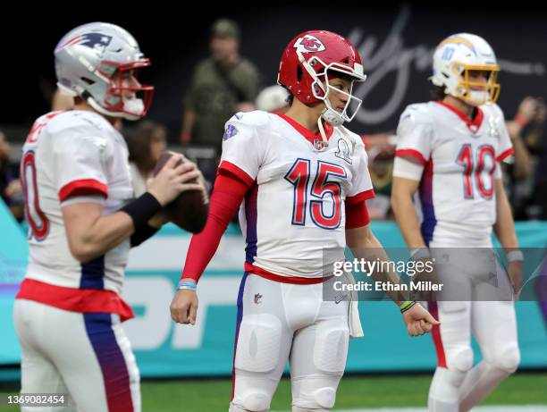 Quarterbacks Mac Jones of the New England Patriots, Patrick Mahomes of the Kansas City Chiefs and Justin Herbert of the Los Angeles Chargers warm up...