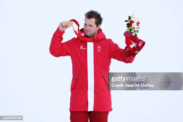 Gold medallist Beat Feuz of Team Switzerland poses during the Men's Downhill medal ceremony on day three of the Beijing 2022 Winter Olympic Games at...
