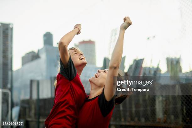 two soccer players celebrate a goal. - championship round two stock pictures, royalty-free photos & images