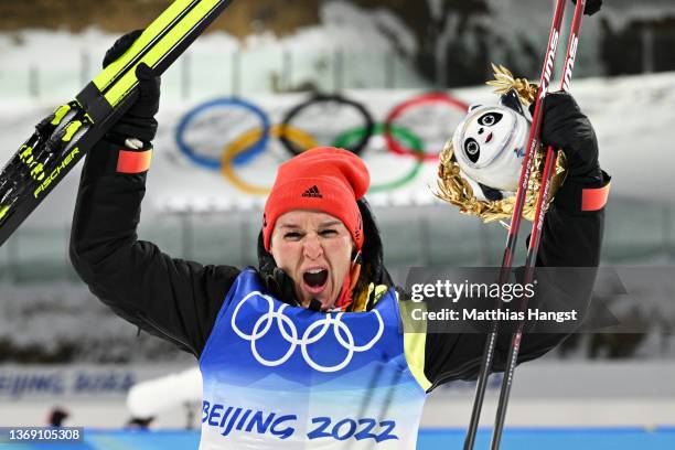 Gold medallist Denise Herrmann of Team Germany celebrates during Women's Biathlon 15km Individual flower ceremony at National Biathlon Centre on...