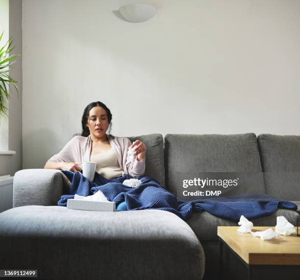 shot of a young woman suffering from a cold at home - allergies indoors stock pictures, royalty-free photos & images