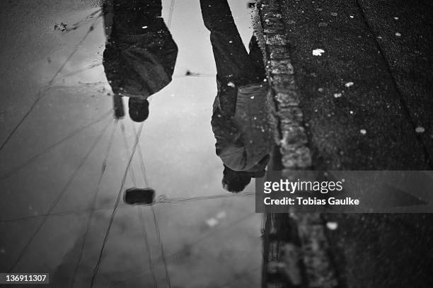 reflection of people in puddle - tobias gaulke stock-fotos und bilder