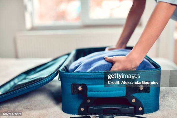 packing time for female before traveling - warm clothing stock pictures, royalty-free photos & images