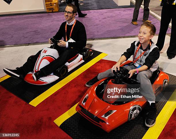 Paid models Camilo Gallardo and Christopher Jacobs demonstrate Inflatable Sports Cars for the Nintendo Wii at the CTA Digital booth at the 2012...