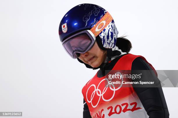 Sara Takanashi of Team Japan shows dejection after being disqualified after jumping in Mixed Team Ski Jumping Final Round at National Ski Jumping...