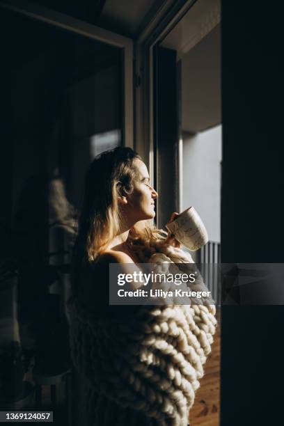 middle-aged woman enjoying her morning coffee. - enjoying coffee cafe morning light stock pictures, royalty-free photos & images
