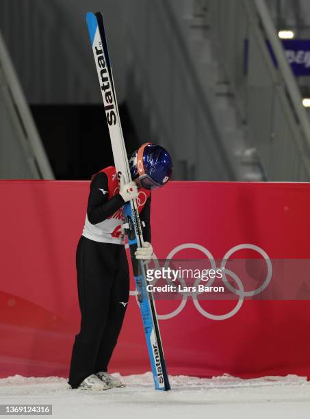 Sara Takanashi of Team Japan shows dejection after being disqualified during Mixed Team Ski Jumping Final Round at National Ski Jumping Centre on...