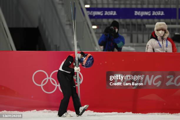 Sara Takanashi of Team Japan shows dejection after being disqualified during Mixed Team Ski Jumping Final Round at National Ski Jumping Centre on...