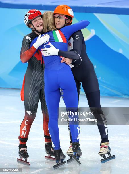 Arianna Fontana of Team Italy celebrates winning the Gold medal with Silver medallist Suzanne Schulting of Team Netherlands and Bronze Medallist Kim...