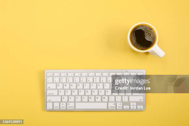 flat lay of coffee with keyboard on yellow background - teclado de ordenador fotografías e imágenes de stock