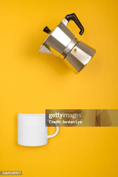 moka coffee maker and an empty cup on yellow background - coffee machine isolated stock pictures, royalty-free photos & images