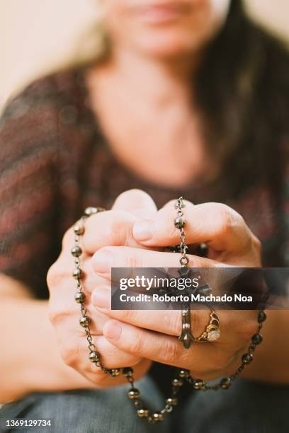 catholic woman praying - rosary beads stock pictures, royalty-free photos & images