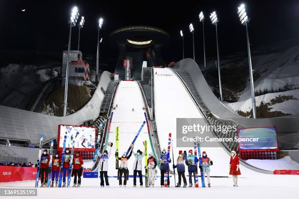 Gold medalists Team Slovenia, Silver medalists Team ROC and Bronze medalists Team Canada celebrate following Mixed Team Ski Jumping Final Round at...