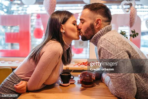 loving couple enjoying kissing on date  on valentines day - valentines couple stock pictures, royalty-free photos & images