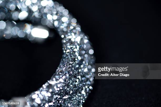 detail of a shiny bracelet on a black background. - diamant bijoux stock pictures, royalty-free photos & images