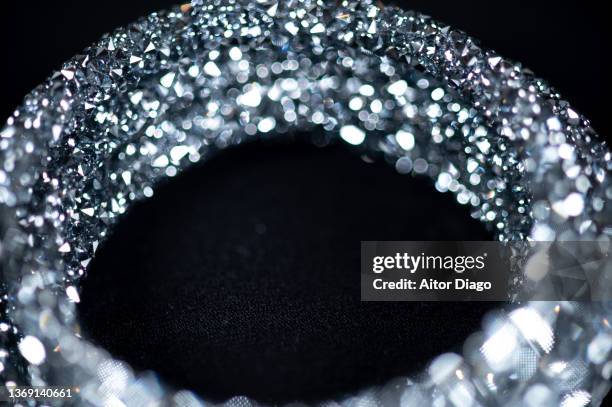 detail of a shiny bracelet on a black background. - spielkarte karo stock-fotos und bilder