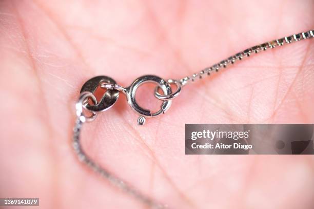 detail of a silver-colored chain - white gold stock pictures, royalty-free photos & images