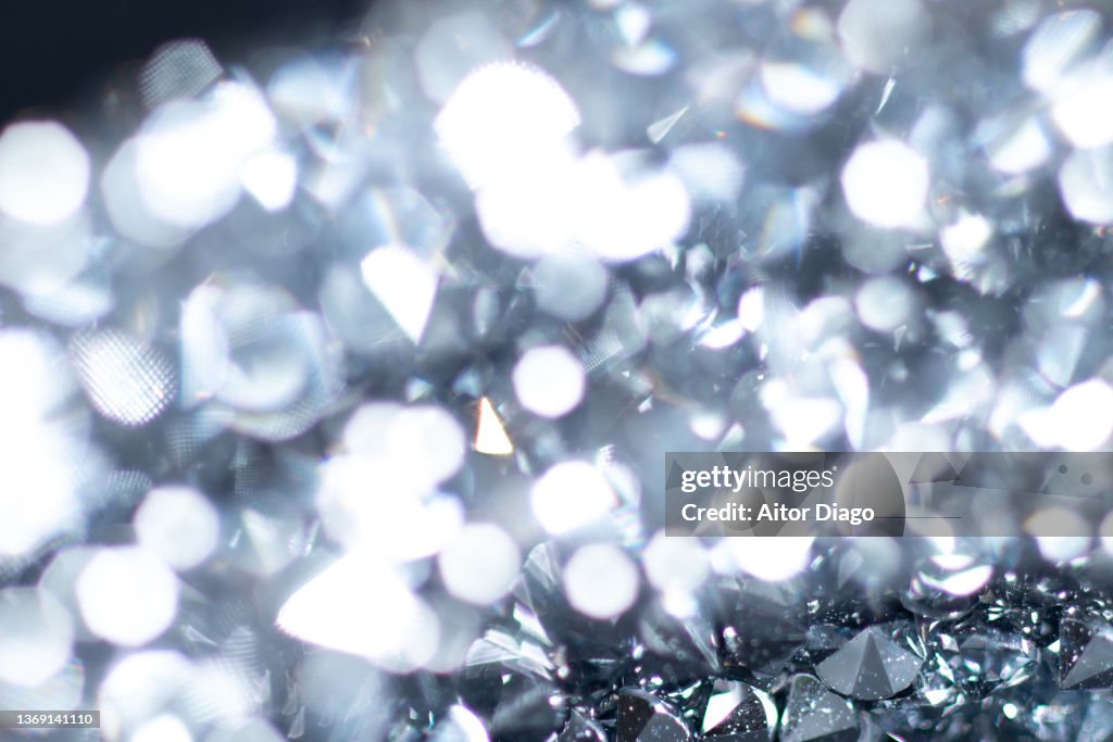 Detail of a piece of jewelry with inlays that look like diamonds.