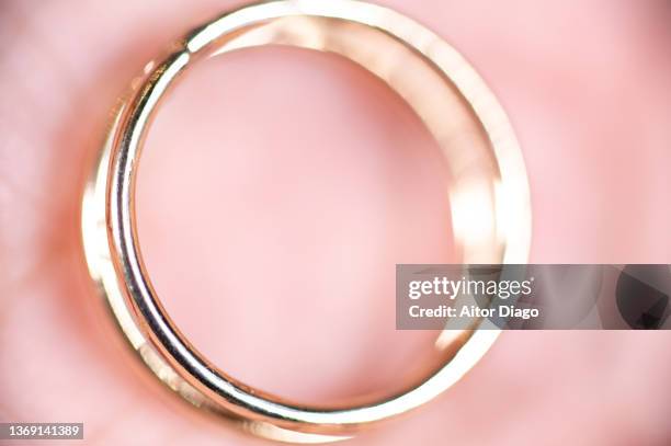 close-up of a gold ring in a persons finger. - costume jewellery stock pictures, royalty-free photos & images