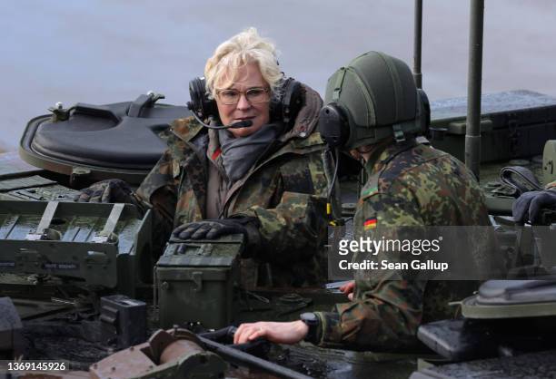 German Defence Minister Christine Lambrecht rides in an armoured vehicle as she attends a demonstration of capabilities of the 9th Panzer Training...