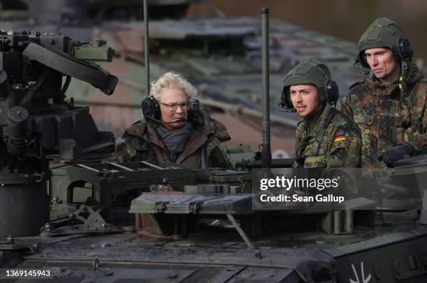 German Defence Minister Christine Lambrecht rides in an armoured vehicle as she attends a demonstration of capabilities of the 9th Panzer Training...