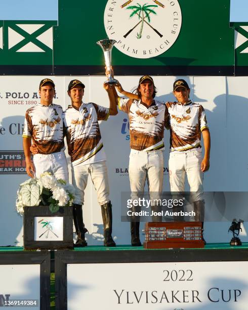 Keko Magrini, Facha Valent, Santino Magrini, and Joaquin Panelo of CK Polo hold the Yvlisaker Cup trophy after defeating La Fe 12-11 after the...