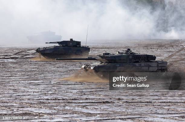 Leopard 2 A6 heavy battle tank and a Puma infantry fighting vehicle of the Bundeswehr's 9th Panzer Training Brigade participate in a demonstration of...