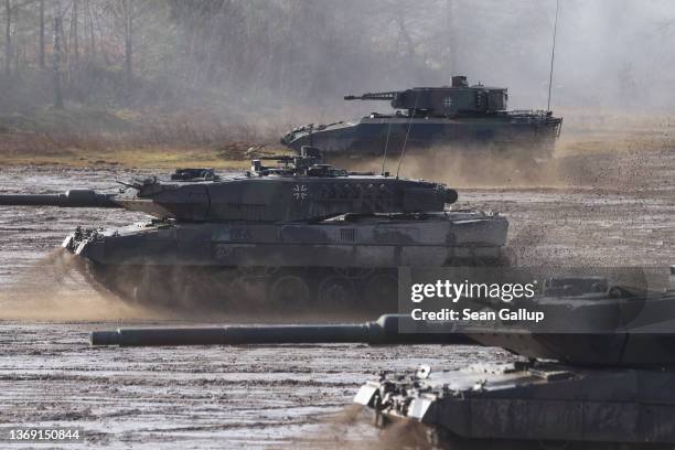 Two Leopard 2 A6 heavy battle tanks and a Puma infantry fighting vehicle of the Bundeswehr's 9th Panzer Training Brigade participate in a...