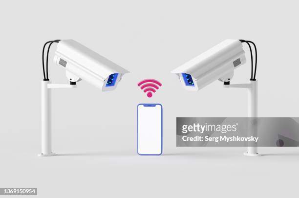smartphone mockup with wifi sign near two white surveillance cameras on white background. - surveillance screen stock pictures, royalty-free photos & images