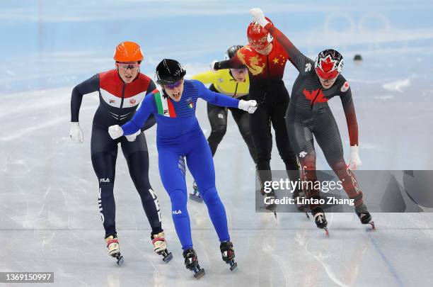 Arianna Fontana of Team Italy crosses the finish line to win the Gold medal ahead of Suzanne Schulting of Team Netherlands and Kim Boutin of Team...