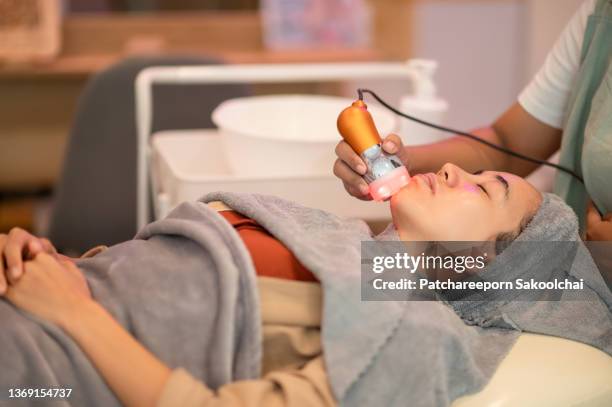 woman in motion of relax feel comfortable in mind of facial spa laser treatment apply to face skincare moisturizing anti of aging - beauty laser bildbanksfoton och bilder