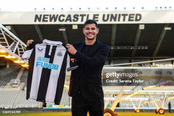 Bruno Guimaraes holds a shirt pitchside during his introduction to the media at the Newcastle United Press Conference at St. James Park on February...