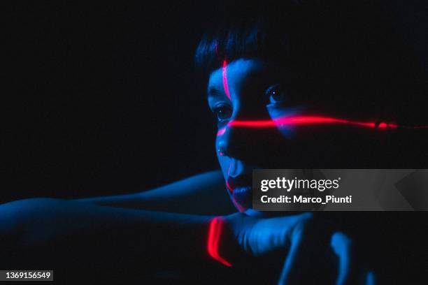 portrait of young woman illuminated neon light and laser - beauty laser bildbanksfoton och bilder