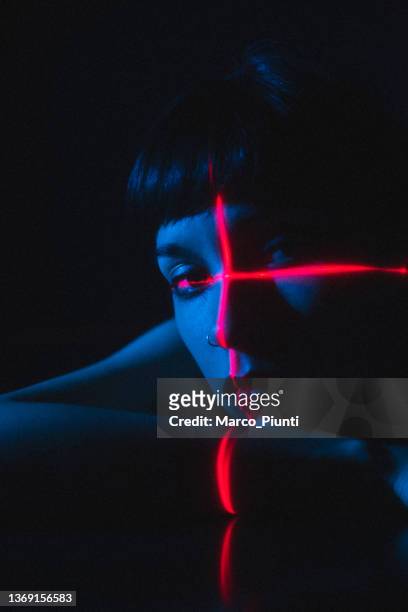 portrait of young woman illuminated neon light and laser - art modeling studio stock pictures, royalty-free photos & images