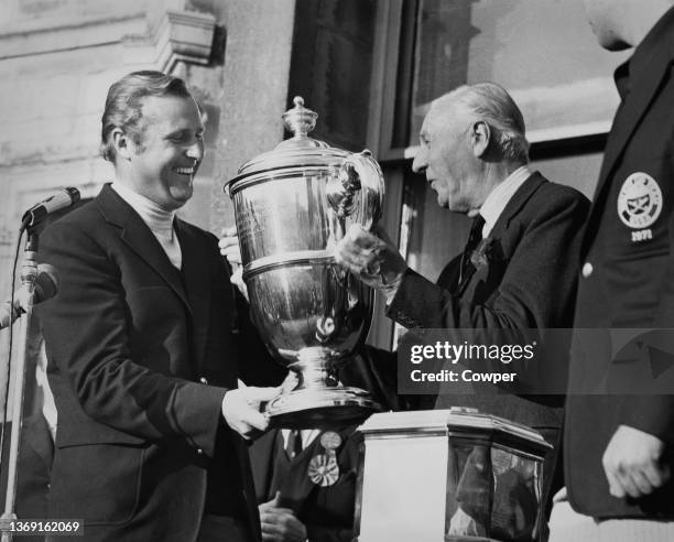 Roger Wethered presents the Walker Cup trophy to Michael Bonallack, team captain for the Great Britain and Ireland team after winning the 23rd Walker...