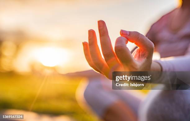 close-up of woman meditating in nature - zen like stock pictures, royalty-free photos & images