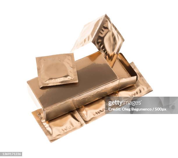 golden condoms in box,high angle view of purse on white background,moldova - condom box stock pictures, royalty-free photos & images