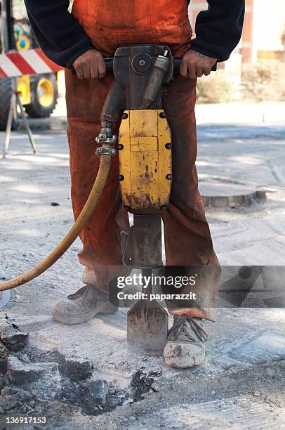 operating a jackhammer - jackhammer stock pictures, royalty-free photos & images